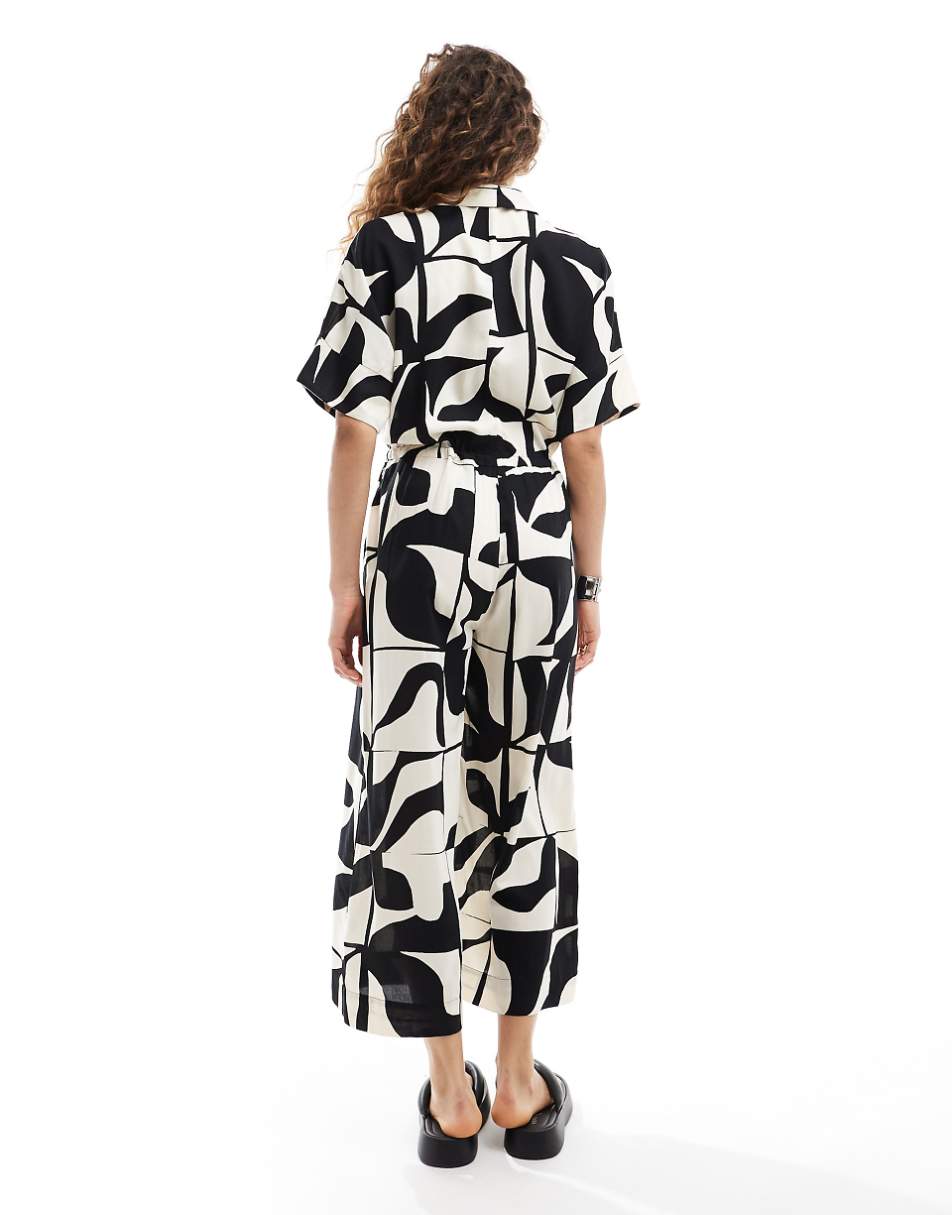 Monki tie waist jumpsuit in black and white puzzle print