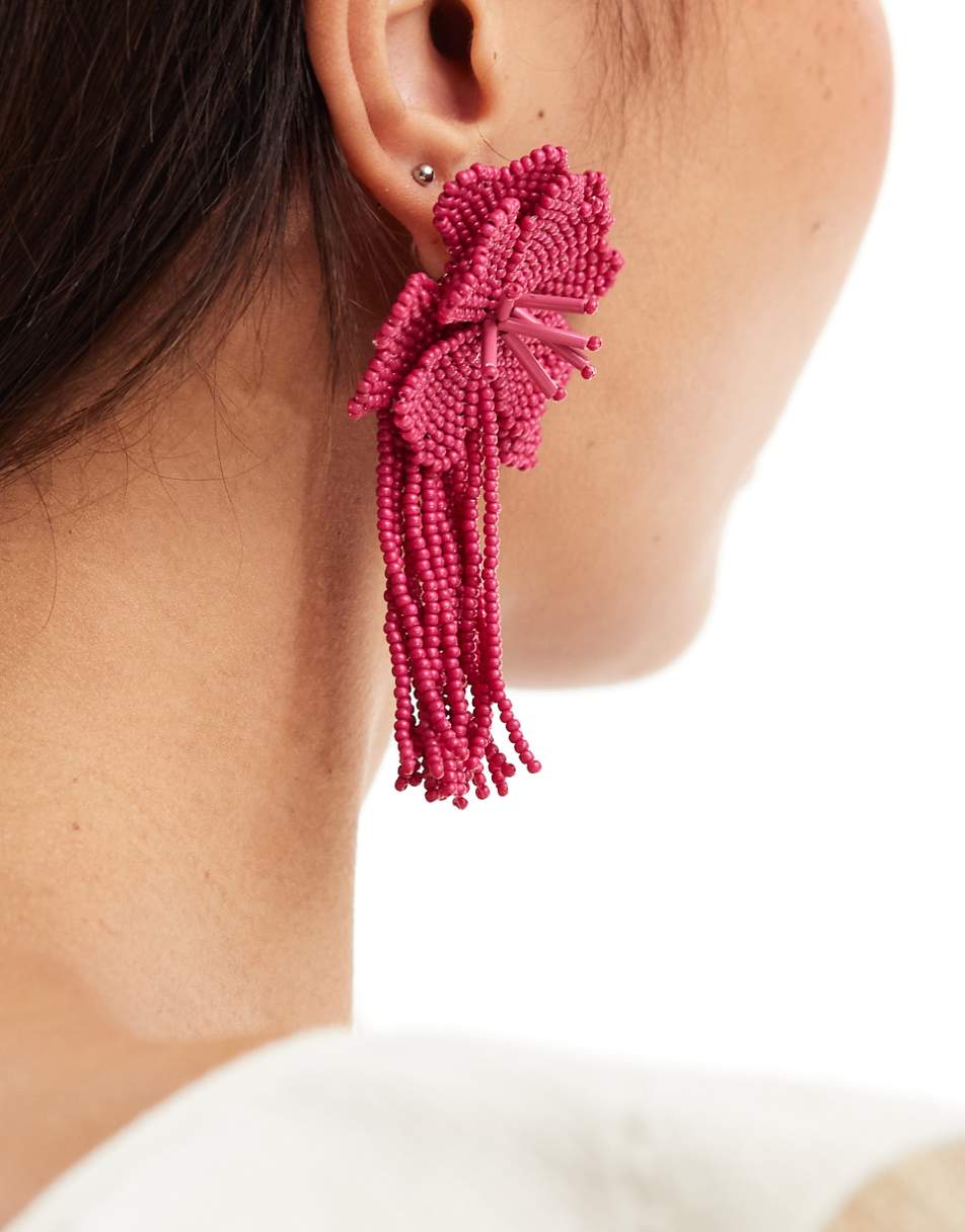 ASOS DESIGN drop earrings with beaded floral design in hot pink