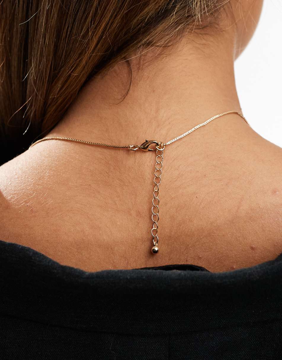 ASOS DESIGN long pendant necklace with flower design in gold tone