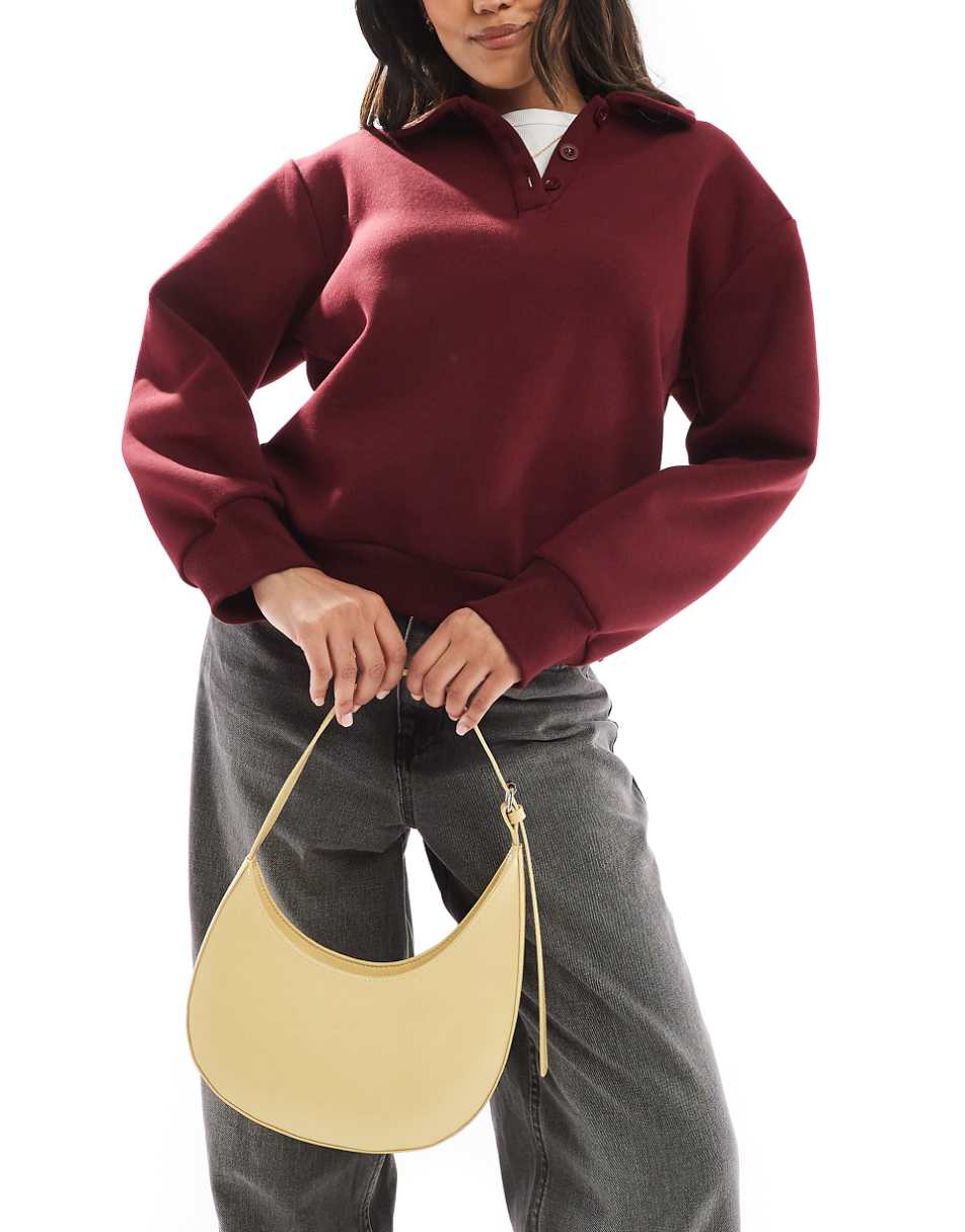 ASOS DESIGN asymmetric scoop shoulder bag with buckle detail in buttermilk