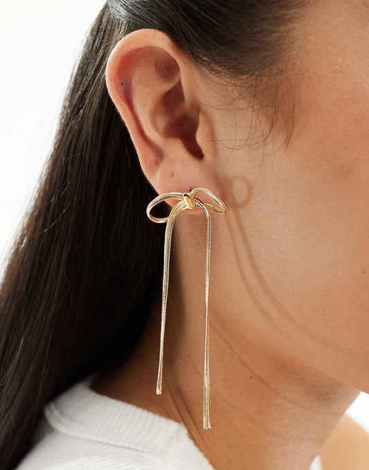 ASOS DESIGN drop earrings with bow chain design in gold tone