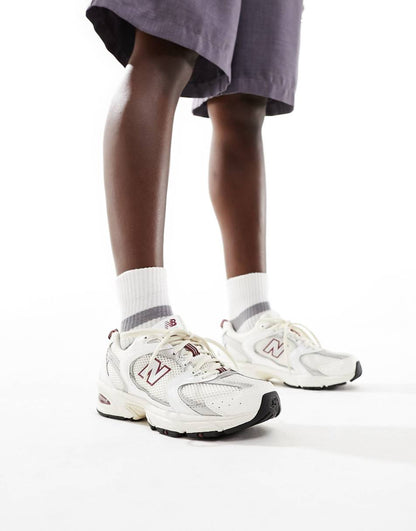 New Balance 530 sneakers in white with red and gray details