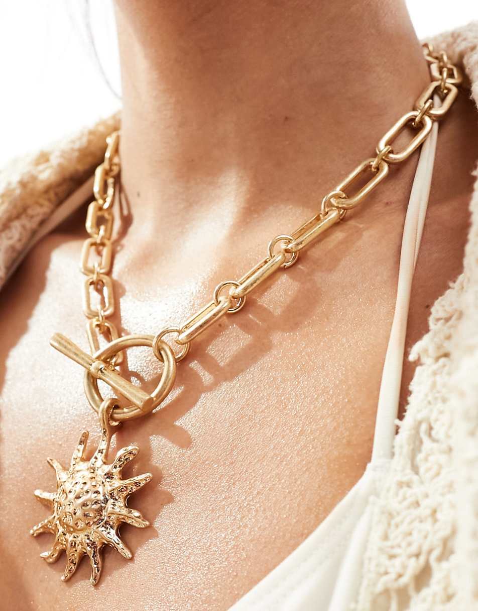 ASOS DESIGN necklace with tbar and sun charm detail in gold tone