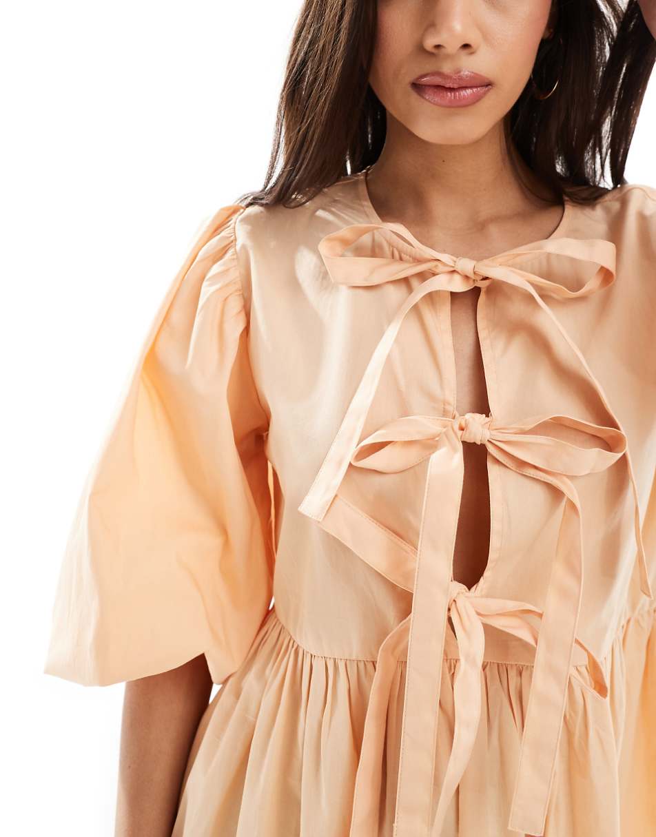 ASOS DESIGN bow tie front mini smock dress in peach fuzz