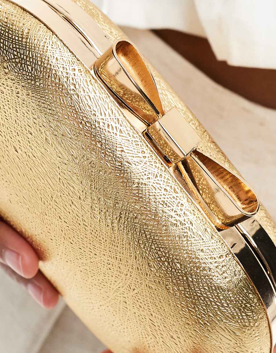 True Decadence box clutch bag with bow clasp in gold