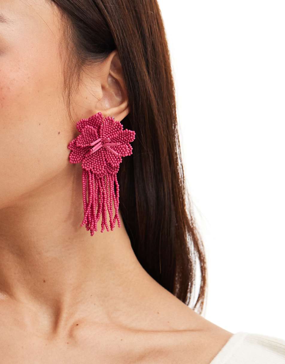 ASOS DESIGN drop earrings with beaded floral design in hot pink