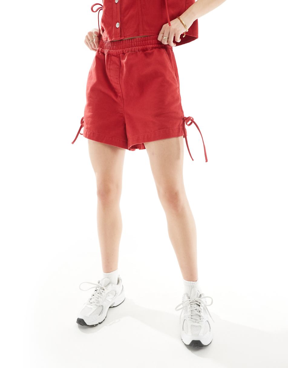 ASOS DESIGN denim shorts with bows in red