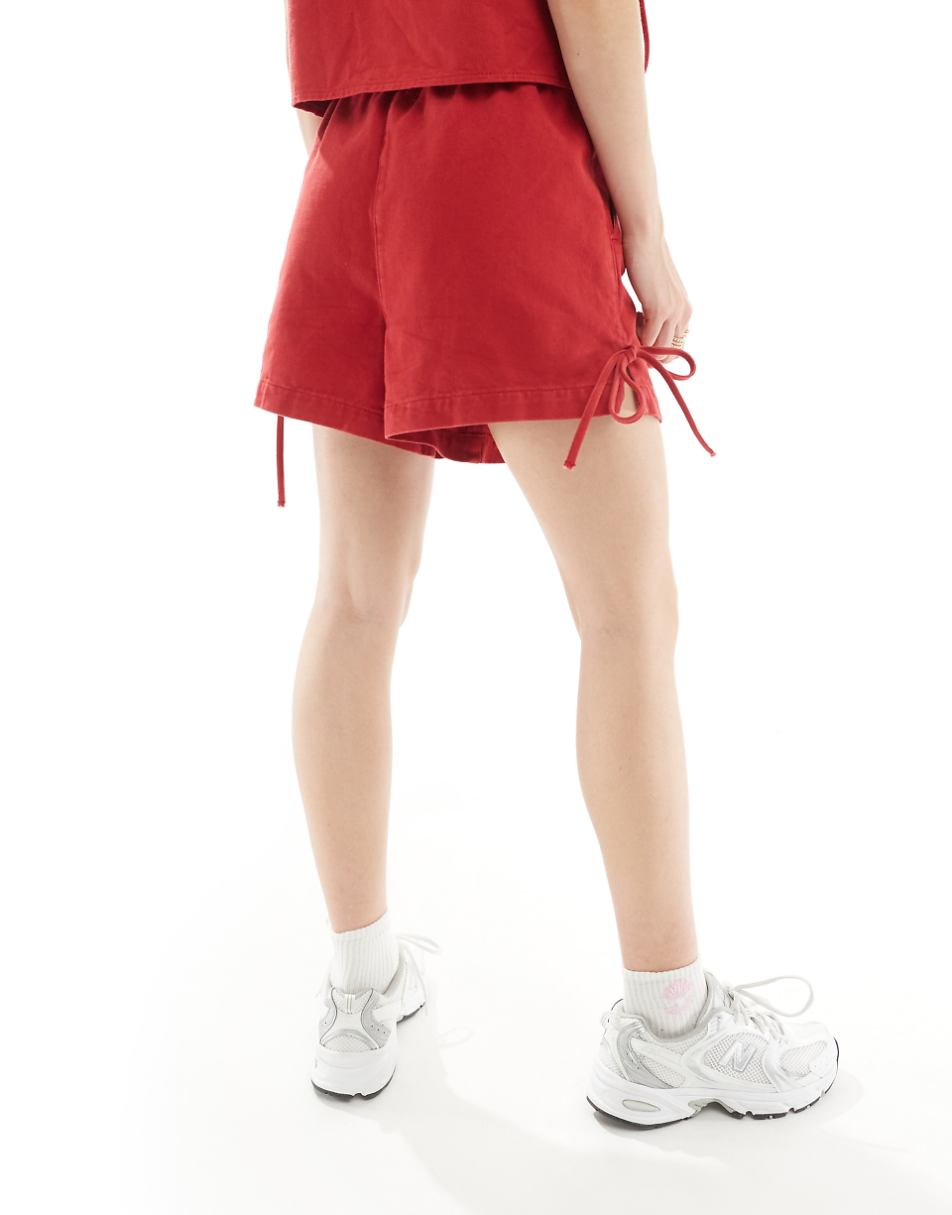 ASOS DESIGN denim shorts with bows in red