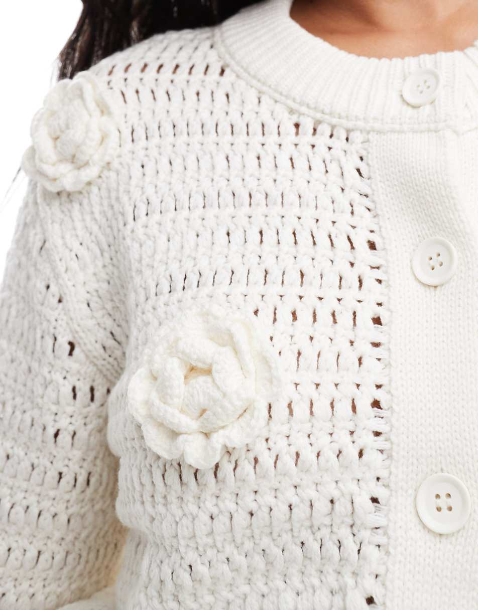 ASOS DESIGN knit crew neck cardigan in open stitch with crochet flower detail in cream