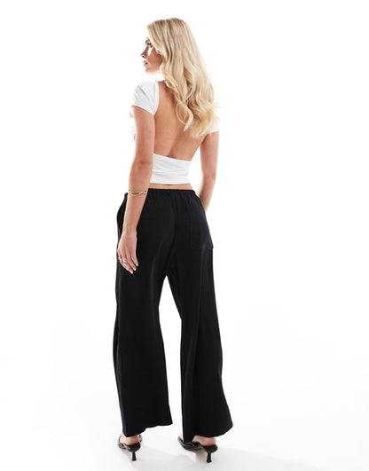 ASOS DESIGN Petite satin pull on pants in black
