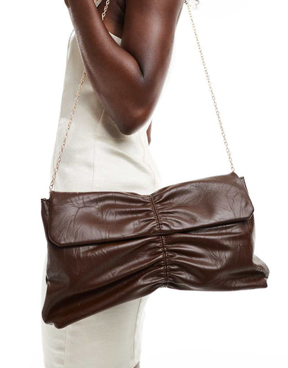 Glamorous rouched clutch bag in brown patent