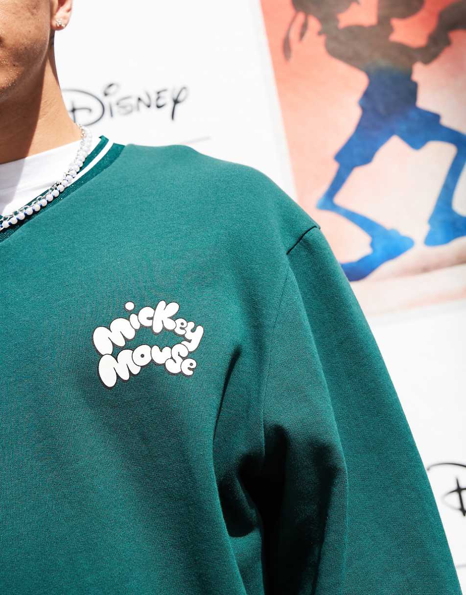 ASOS DESIGN Disney unisex boxy fit v neck sweatshirt with Mickey Mouse prints in green