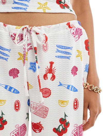 ASOS DESIGN textured wide leg pants in summer food print - part of a set