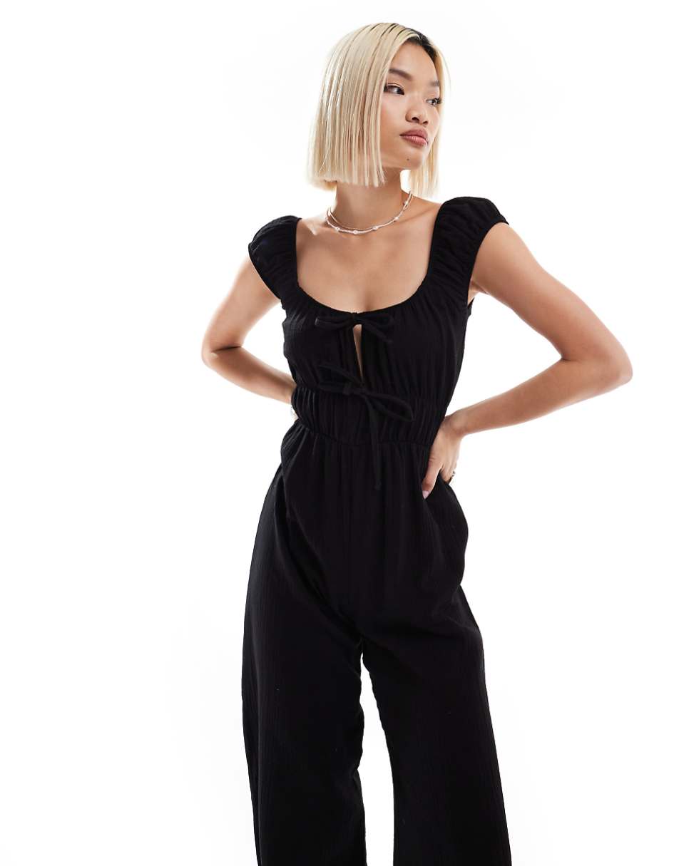 Reclaimed Vintage textured tie front jumpsuit in black